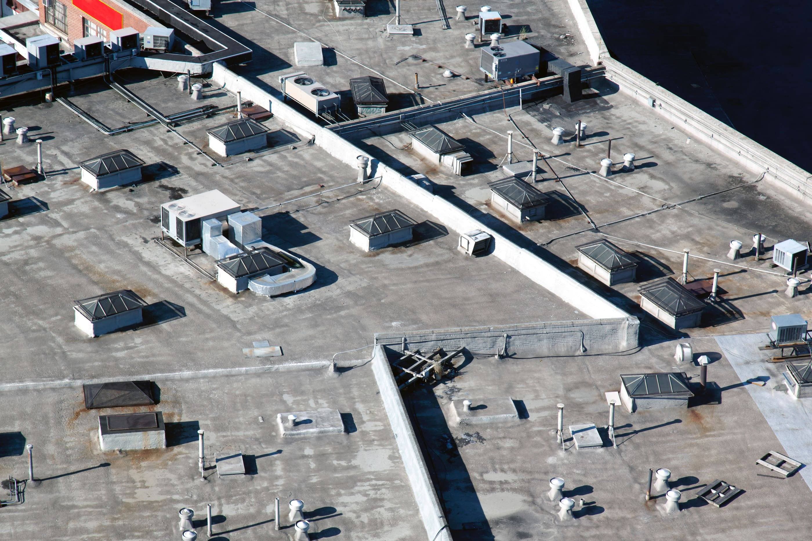 Overhead view of NYC rooftop filled with heating-cooling units