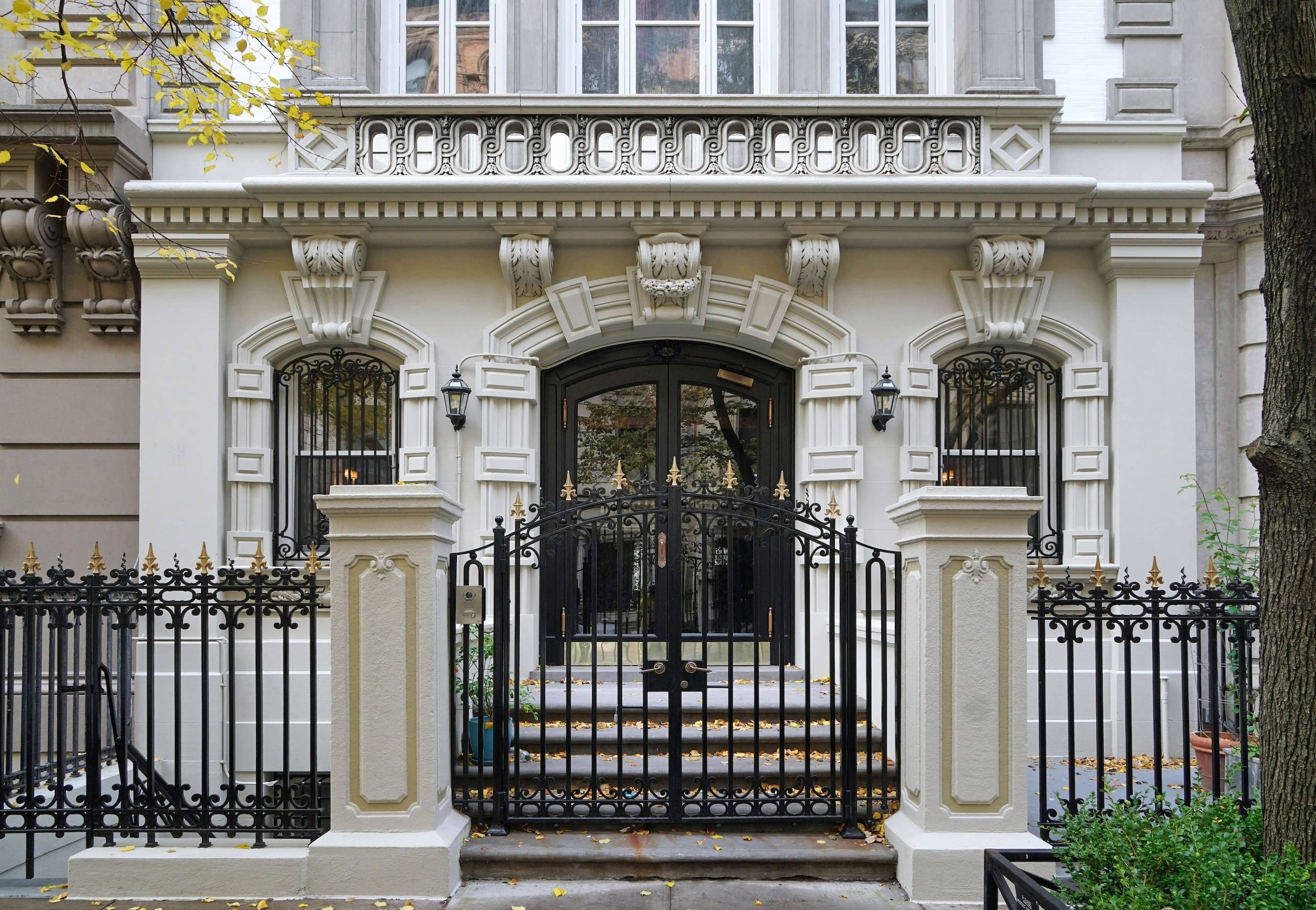 A house with an ornate gate and wrought iron fence.