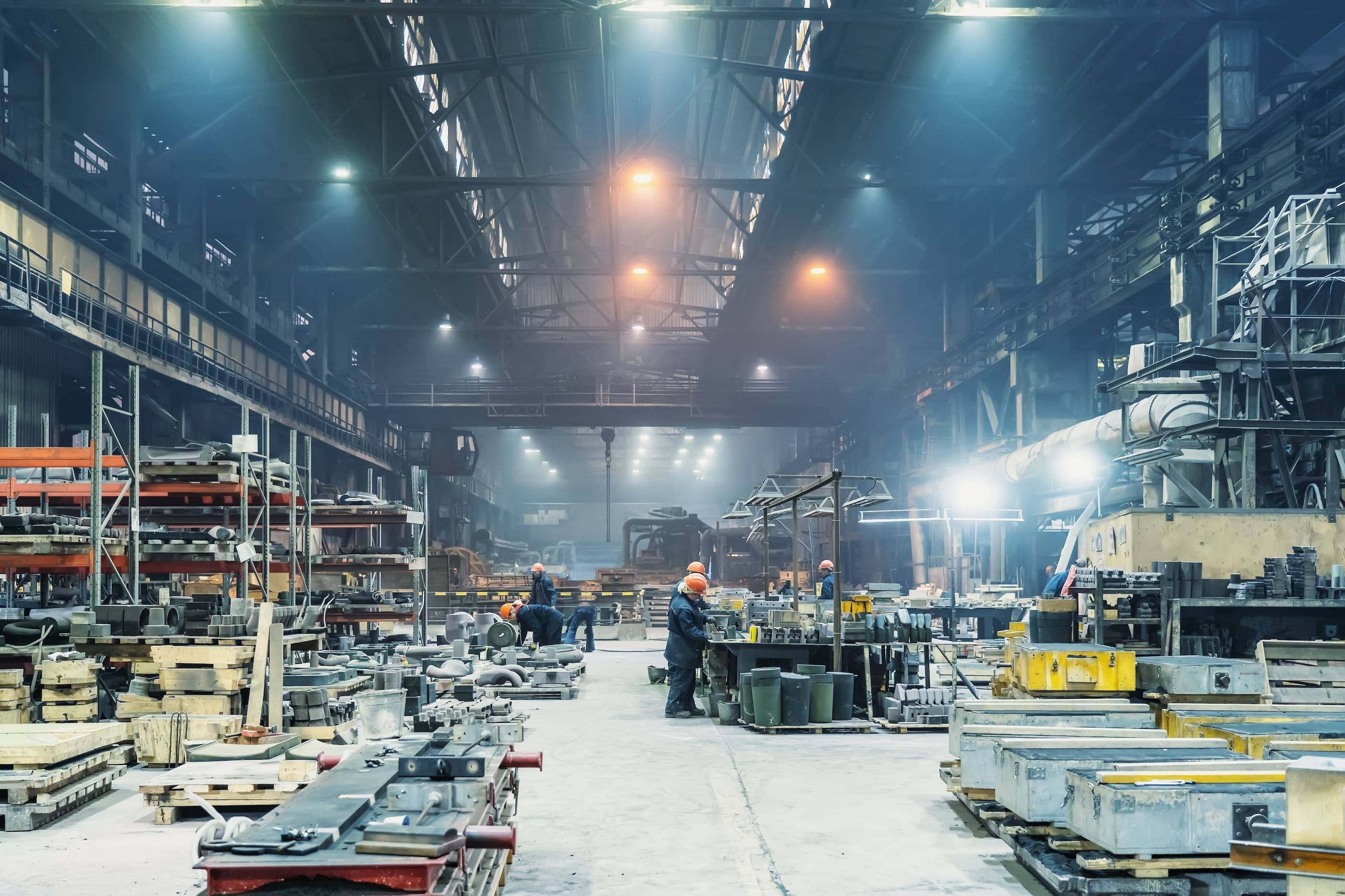 An industrial factory with workers working in it.