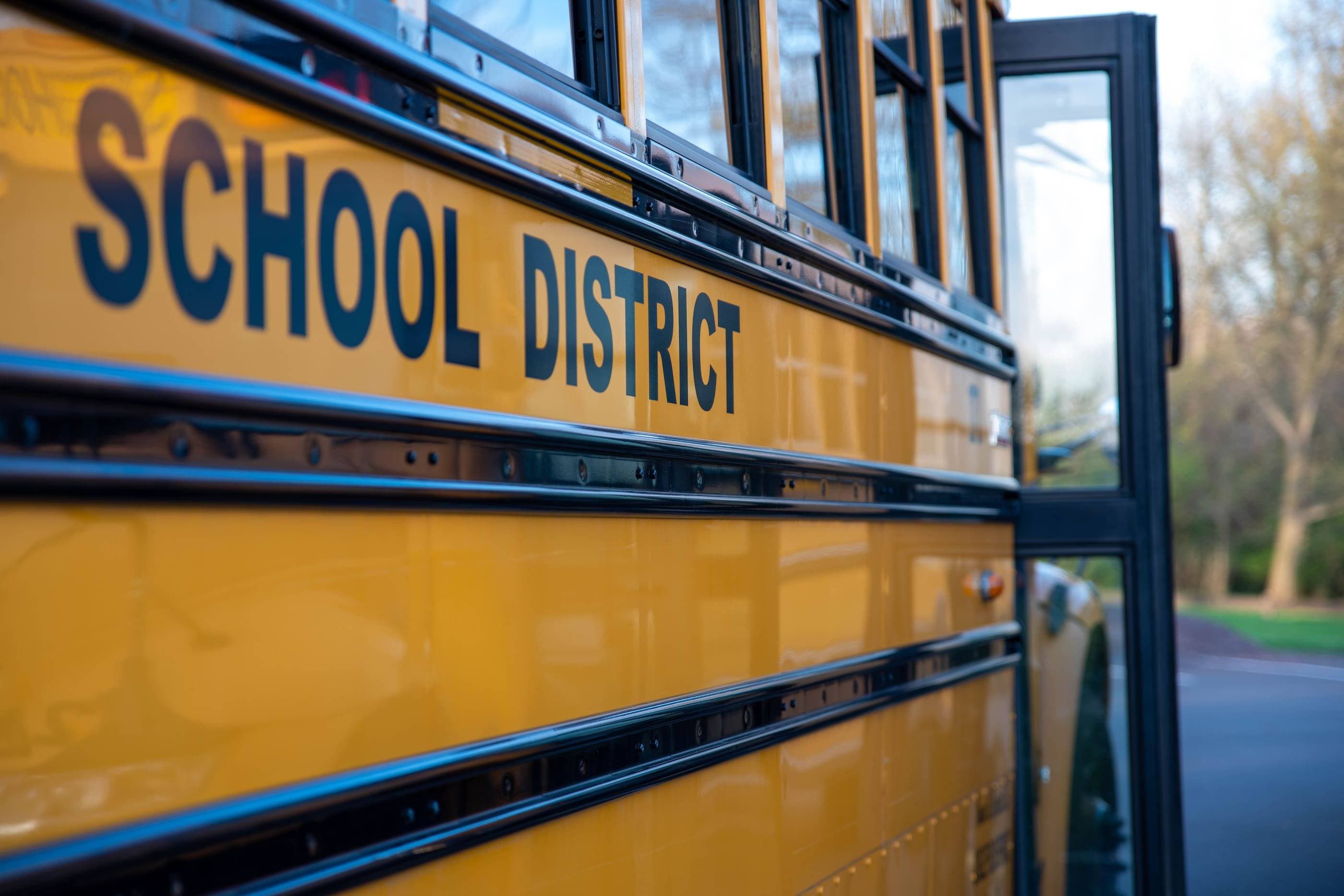 A yellow school bus with the words school district on it.