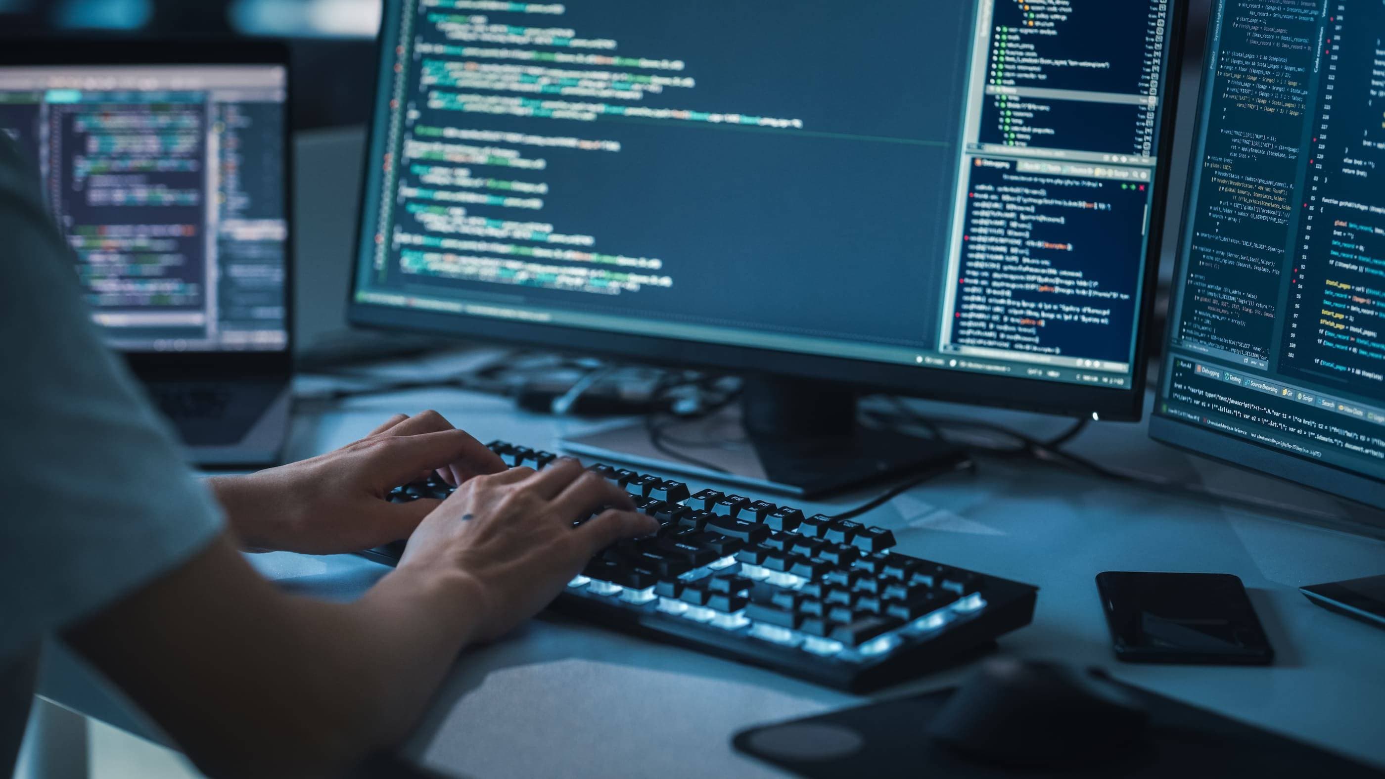 A person is working on a computer with two monitors.