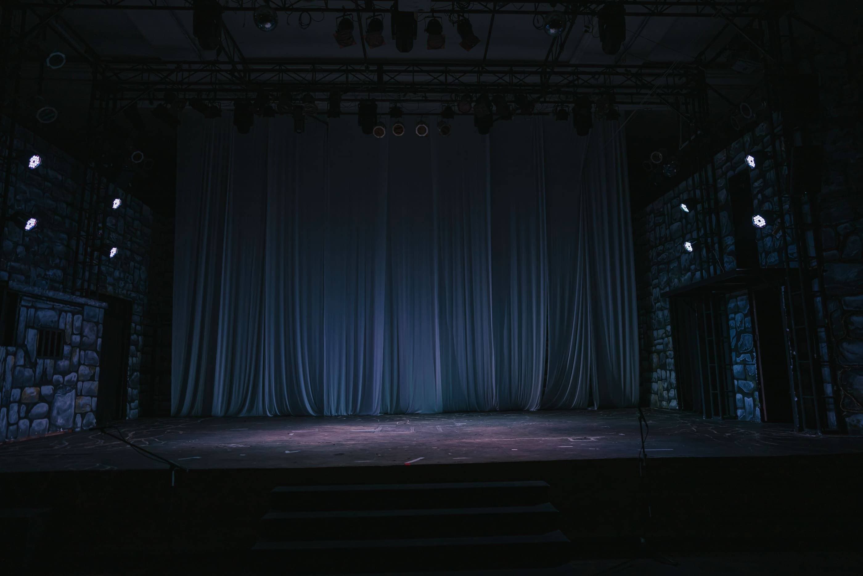 A stage with a curtain and lights on it.