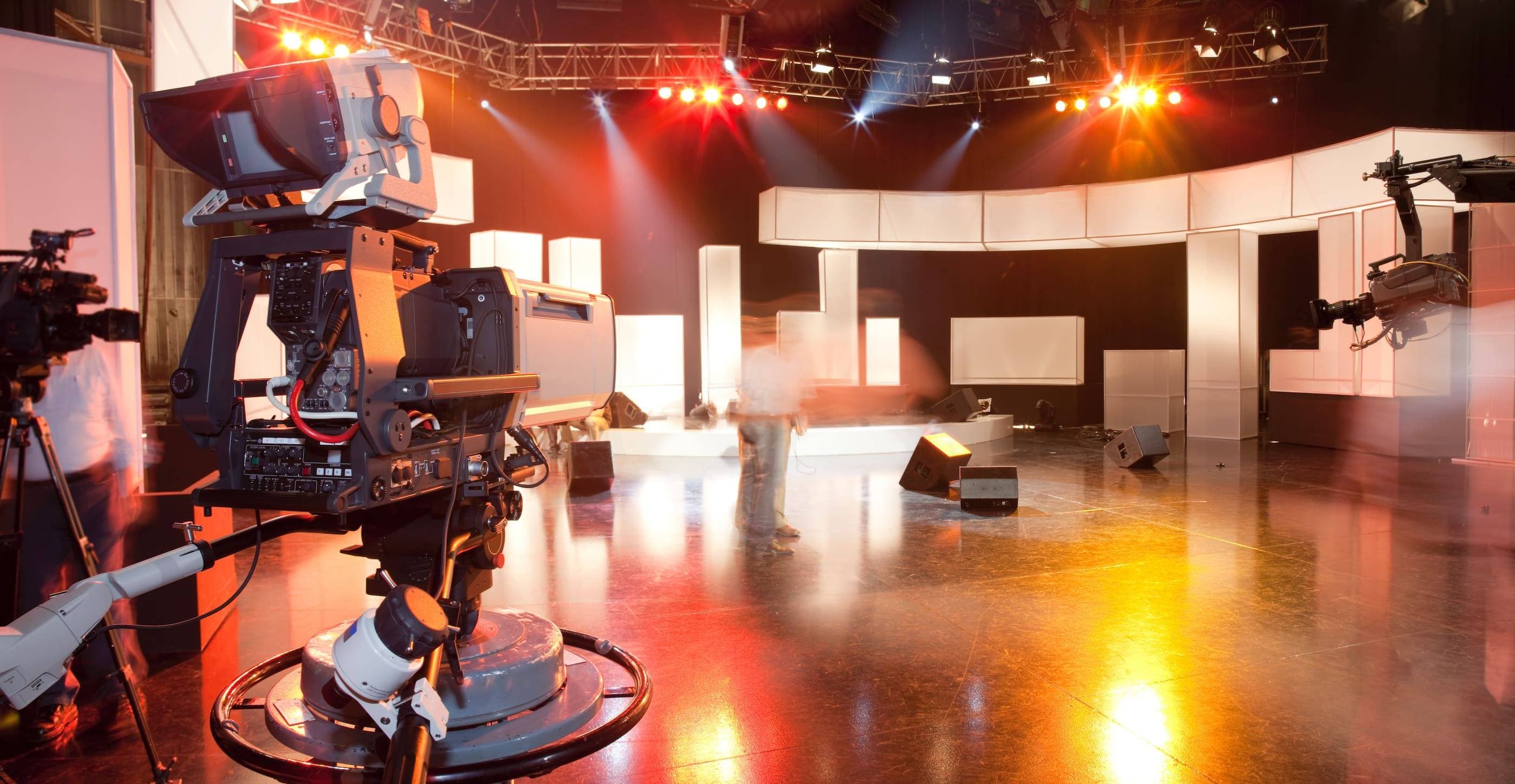 A tv studio with a camera and lighting equipment.