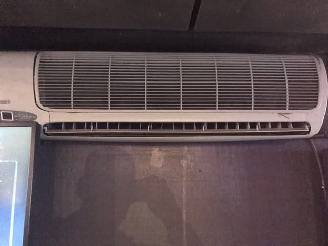 An air conditioner sitting on top of a desk.