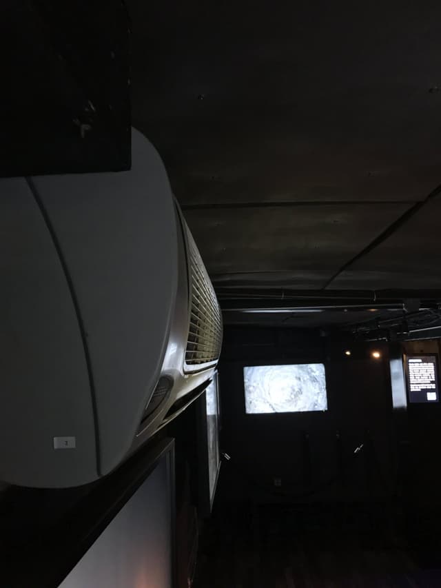 An air conditioning unit in a dark room.