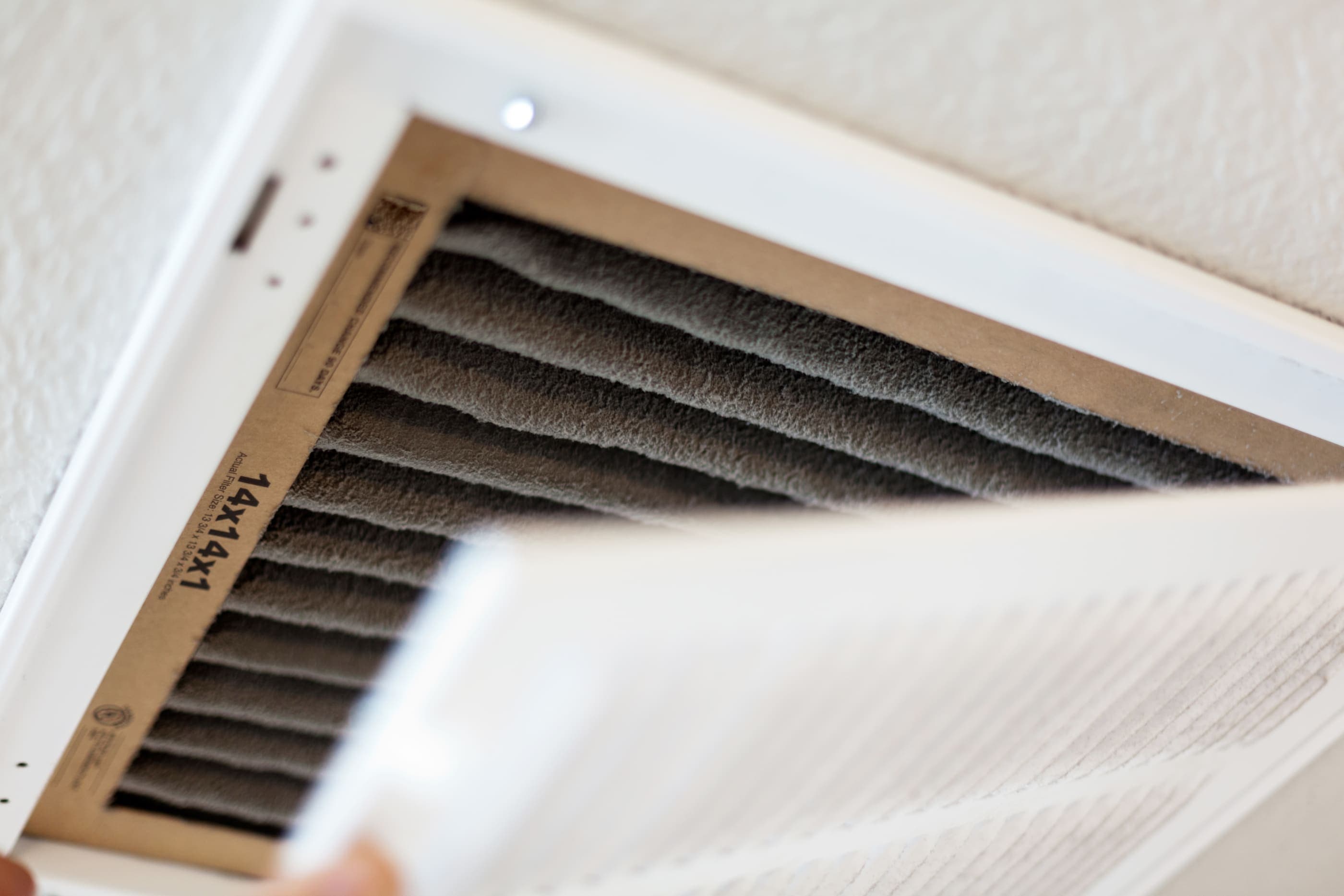 A close up of an air filter in a wall.