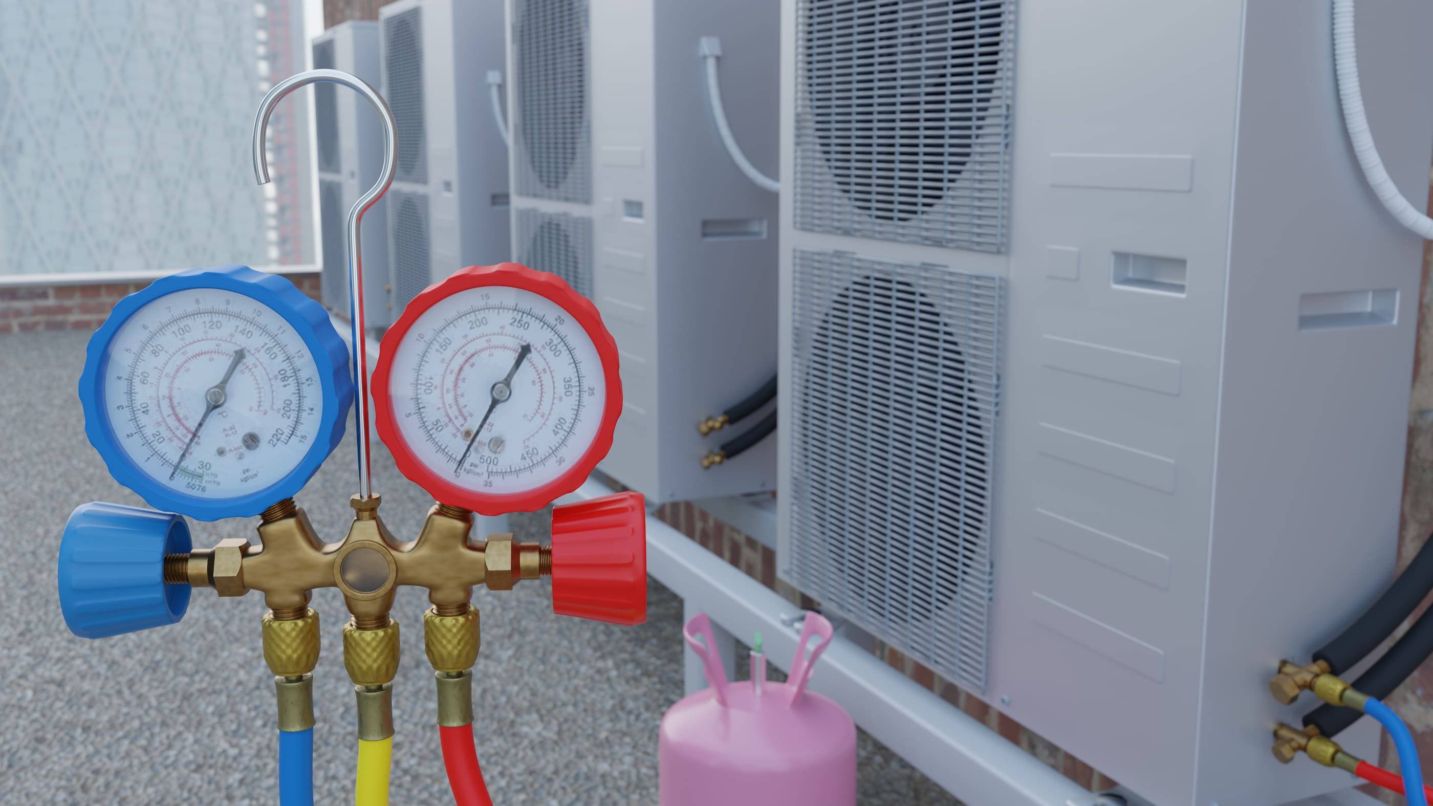 A group of air conditioners with pressure gauges in front of them.