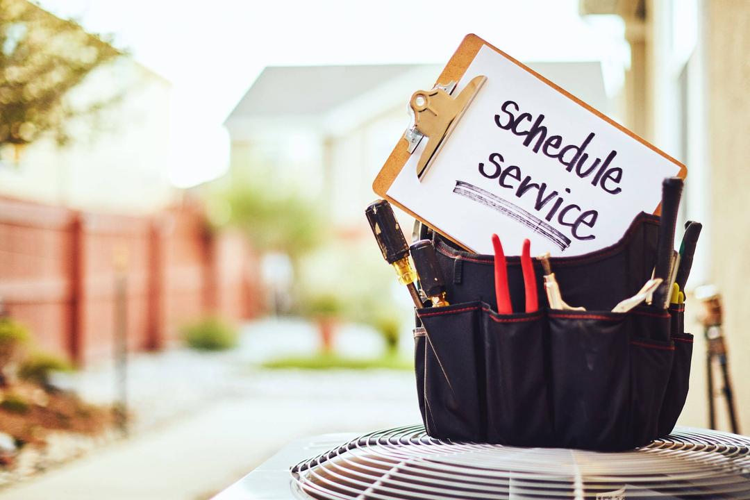 A clipboard with a sign that says schedule services on it.