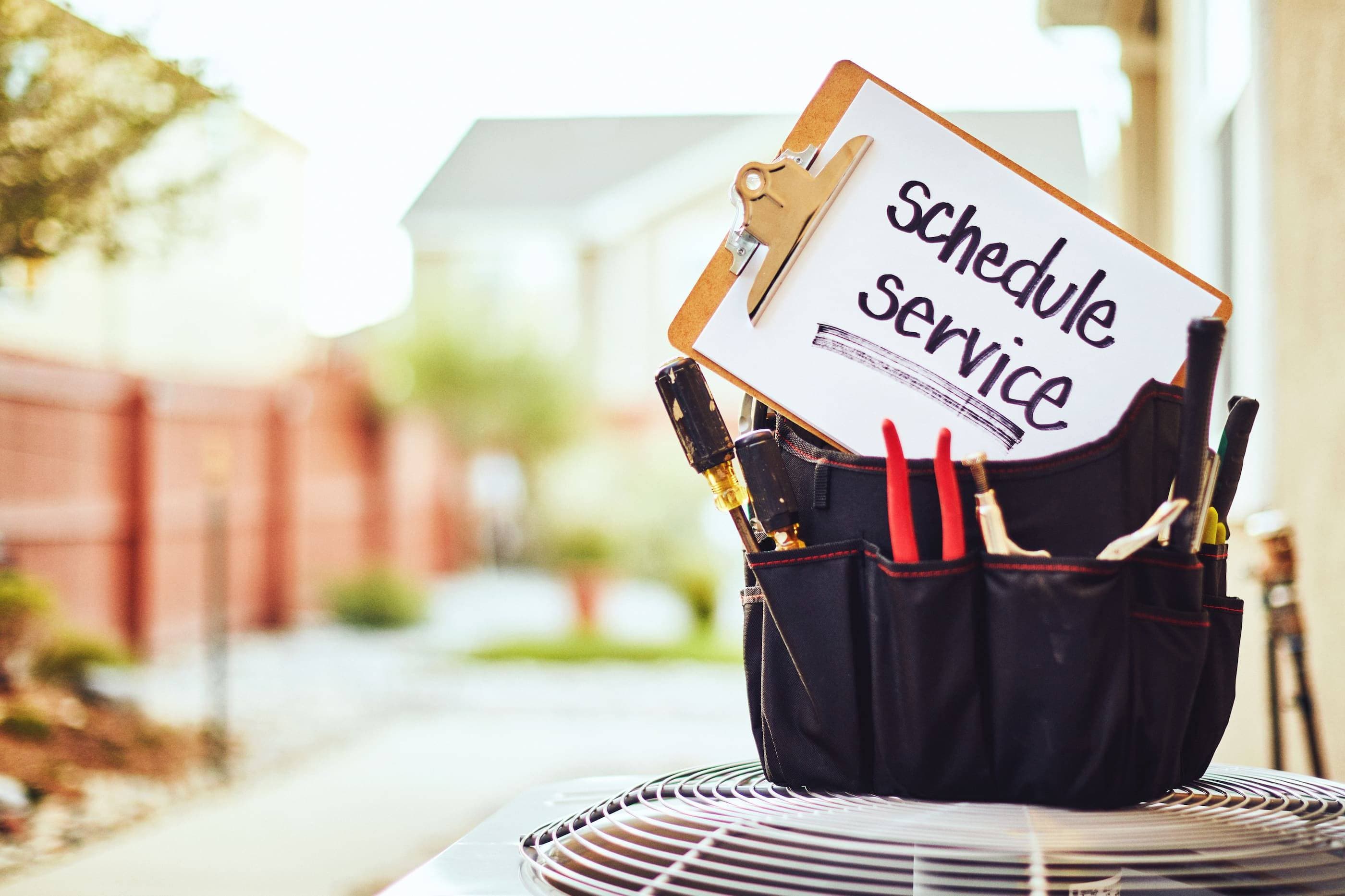 A clipboard with a sign that says schedule services on it.