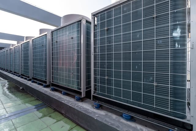 A row of air conditioners in a building.