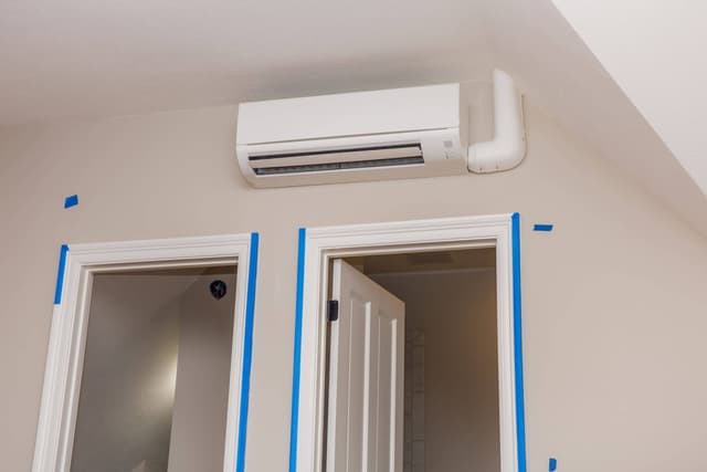 A room with an air conditioner hanging from the ceiling.